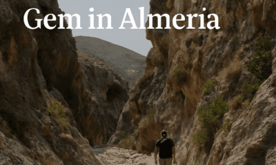 A lone hiker explores Barranco del Infierno canyon in Almería, Spain, surrounded by rocky cliffs and dramatic natural scenery.