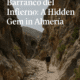A lone hiker explores Barranco del Infierno canyon in Almería, Spain, surrounded by rocky cliffs and dramatic natural scenery.