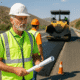 Road construction workers resurfacing a highway near Almería under clear skies