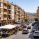 Albox town centre during market day, showing traffic, apartment blocks and a busy commercial street