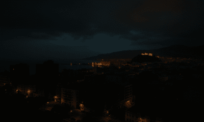 Nighttime view of Almería with partial city lights and illuminated Alcazaba during a power restoration after nationwide blackout