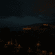 Nighttime view of Almería with partial city lights and illuminated Alcazaba during a power restoration after nationwide blackout