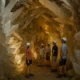 Visitors exploring the Pulpi Geode with giant translucent crystals