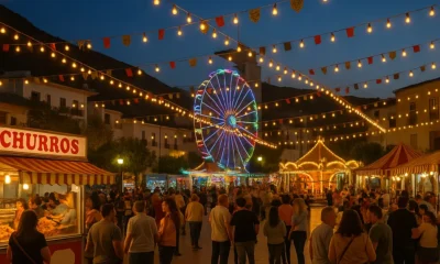 Albox All Saints Fair 2025 at night with colourful lights, fairground rides and people enjoying the festivities in southern Spain