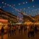 Albox All Saints Fair 2025 at night with colourful lights, fairground rides and people enjoying the festivities in southern Spain