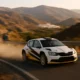 White and black rally car speeding along a winding mountain road during the Rally Costa de Almeria 2025, with dust and motion blur under the Andalusian sun.