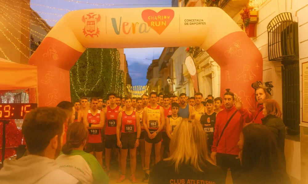 Runners gathering at the start of a Christmas charity run in Vera with festive street decorations