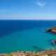 Turquoise Mediterranean sea near Agua Amarga with rocky coastline in Cabo de Gata Natural Park, Almeria