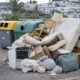 Bulky waste dumped beside recycling bins in Mojacar