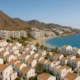 Coastal town in Almeria showing a mix of homes and tourist rentals under Mediterranean light.