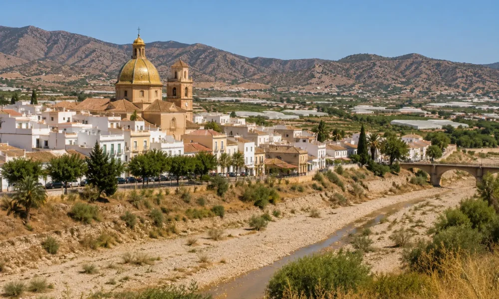View of Zurgena in the Almanzora Valley with its distinctive golden-domed church and dry riverbed in Almeria province.