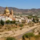 View of Zurgena in the Almanzora Valley with its distinctive golden-domed church and dry riverbed in Almeria province.