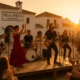 Outdoor flamenco rock concert at sunset in Villa Africa, Aguadulce with audience enjoying the music.
