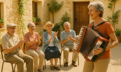Elderly people enjoying an outdoor accordion music session at Almeria community center.