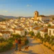 Couple walking dog in a peaceful small town in Almeria under warm Mediterranean light