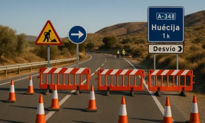 Traffic closure on A-348 near Huecija with roadwork barriers and detour signs under Mediterranean sunlight