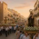 Evening Virgen del Carmen procession through Almeria city streets with people and historic buildings