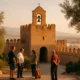 Alcazaba fortress with Torre de la Vela bell during afternoon light and locals gathering in September