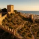 Almeria's Alcazaba fortress and medieval walls bathed in warm Mediterranean light with the city in the background.