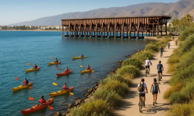 Kayakers, cyclists, and walkers enjoying coastal routes near Cable Ingles pier in Almeria.