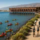 Kayakers, cyclists, and walkers enjoying coastal routes near Cable Ingles pier in Almeria.