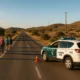 Pedestrians walking safely on rural Almeria road with Civil Guard patrol conducting checks