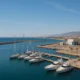 Panoramic view of Almerimar port with marina, yachts, and coastal infrastructure in natural daylight.