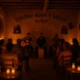 Candlelit live music event inside Centro Agua y Salud in Albox with local audience in warm Mediterranean setting
