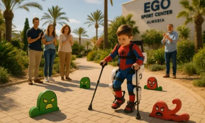 Four-year-old Diego in Spiderman suit walking with pediatric exoskeleton in Almeria during rehabilitation.