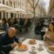 Outdoor café terrace on Paseo de Almería with locals enjoying traditional breakfast dishes in natural light