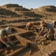 Volunteers excavating at Los Millares archaeological site near Almeria under morning Mediterranean light