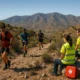 Trail runners and medical volunteers with defibrillators on rugged Almeria mountain trail