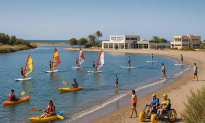 People enjoying various watersports at Nueva Almeria beach with inclusive activities and clear Mediterranean sky